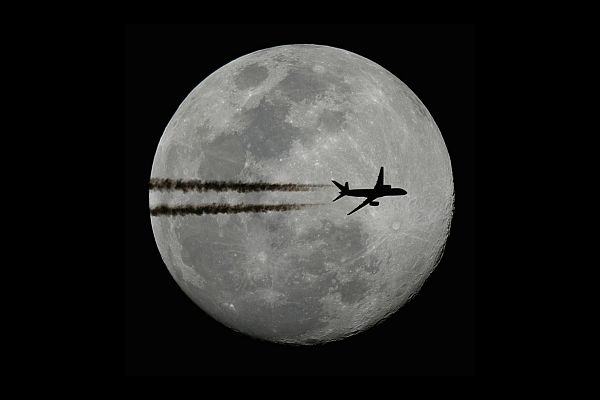 Plane in front of the moon